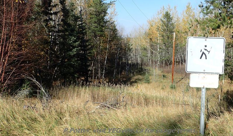 Somewhat shot up no hunting sign along a powerline right of way, Bridge Lake NA, P. Potter, October 1, 2023.