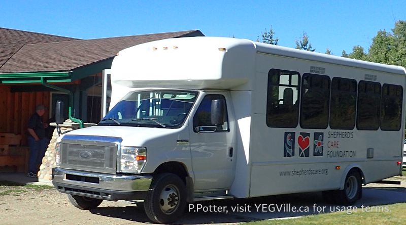 A gaggle of seniors exit their bus for a day at the site, John, one of the volunteers seen against the building on the left, Peaceful Valley PRA, 2024-09-24, P. Potter.