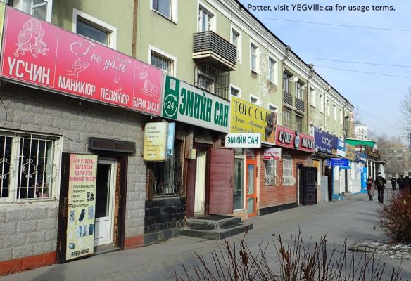 Cheek by jowl shops lining a busy walking street, walk about Ulaanbaatar, 2025-11-22, P. Potter.