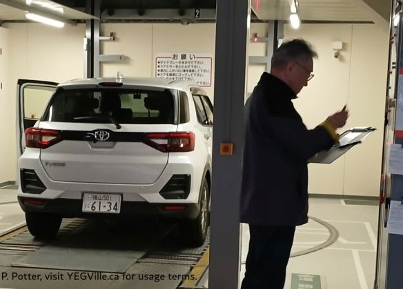 A car being loaded into the automated storage facility at the hotel; too small for Helga, 2026-03-28, P. Potter.