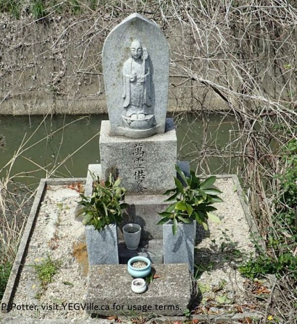 Likely a Jizō shrine (地蔵堂 / お地蔵さん), placed here for travelers and next to a canal, 2026-04-05, Imabari Castle, P. Potter.