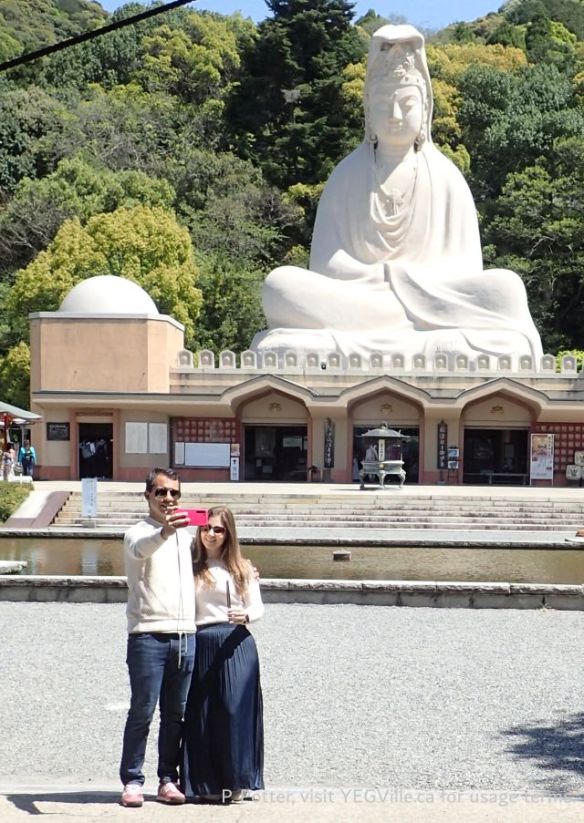 A couple posing in front of the Ryozen Kannon (霊山観音), a prominent war memorial and Buddhist temple located in the Higashiyama district of Kyoto, Japan; it honours both Japanese and Allied war dead, 2026-04-16, Toji Temple environ, Kyoto Japan, P. Potter.